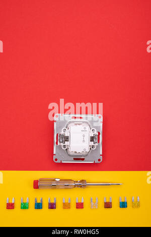 Set of electrical tool and white socket on colorful background Stock Photo