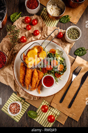 Traditional japanese tempura shrimps with sauce, fresh green salad and fried potatoes Stock Photo