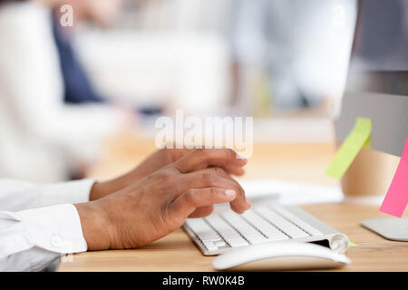 Close up employee hands typing on computer Stock Photo