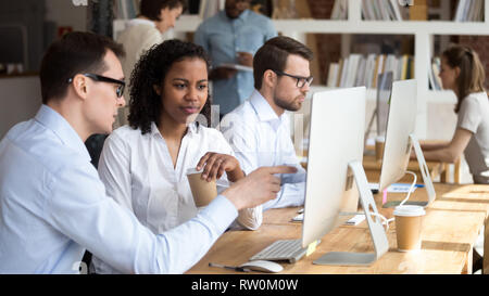 Multiracial people working in coworking office, mentor teach trainee Stock Photo