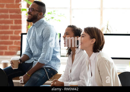 Diverse employees listening coach laughing during project presentation Stock Photo