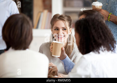 Colleagues take a break during working day talking drinking coffee Stock Photo