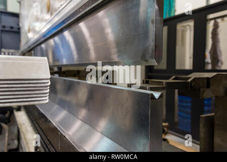 Automatic metal sheet bending machine at work in factory. CNC Panel ...