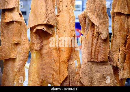Fillets of dried salted Pirarucu, or Arapaima gigas, the largest freshwater fish of the Amazon River of Brazil, hanging in a fish market Stock Photo