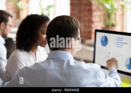 Diverse male female working together using computer Stock Photo