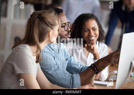 Black team leader working together with females colleagues on project Stock Photo