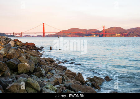 Golden Gate Bridge, the most internationally recognized symbol of San Francisco, in warm red color of aurora Stock Photo