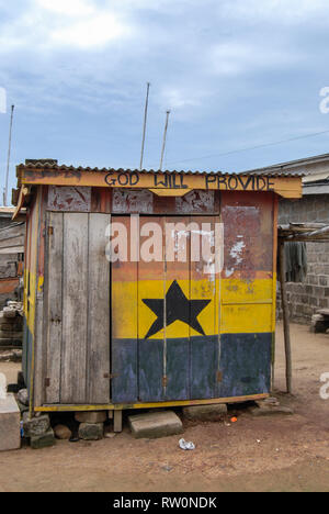 A little shack or hut painted in the colors of Ghanaian flag in the town of Elmina, Ghana Stock Photo