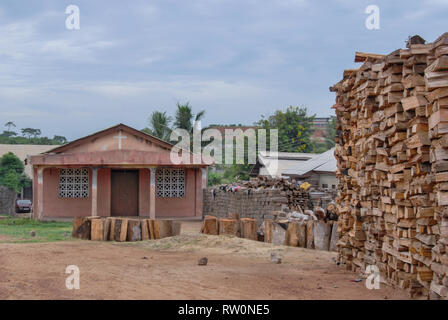 A photo of firewood stacked in front of a local house in the Ghanaian town of Elmina, West Africa Stock Photo