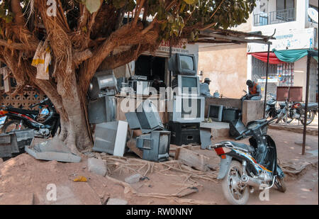A pile of old tvs (television sets) in front of a tv repair shop in Bolgatanga, Ghana, West Africa Stock Photo