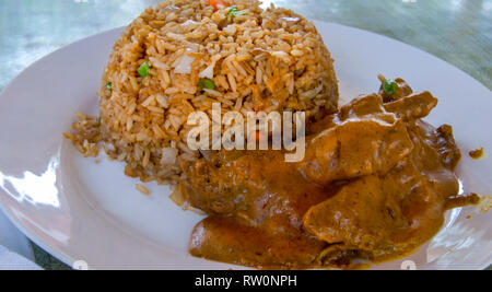 A traditional Ghanaian dish served on a white plate. Stock Photo