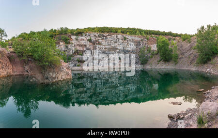 Abandoned marble open mine in Bulgaria with lake inside Stock Photo