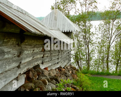 Plinths of windows of wooden houses. Ancient style of decoration of window frames. Stock Photo