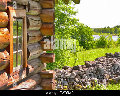 Plinths of windows of wooden houses. Ancient style of decoration of window frames. Stock Photo