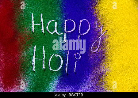 Happy Holi on colorful color powder Stock Photo