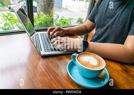 Side view of freelancer working on laptop Stock Photo