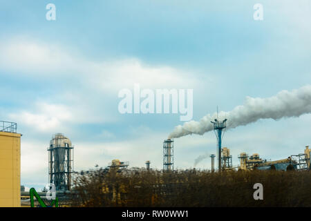 A large plan of the plant pipe, which produces harmful smoke in the environment against the background of the sky 2019 Stock Photo