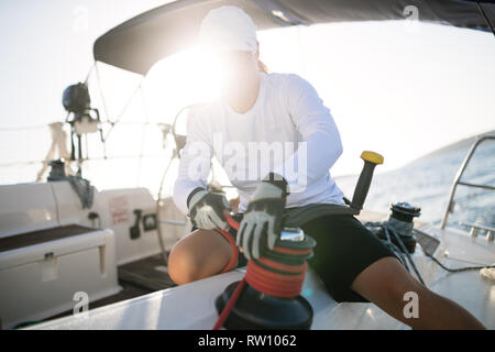 Attractive strong woman sailing with her boat Stock Photo