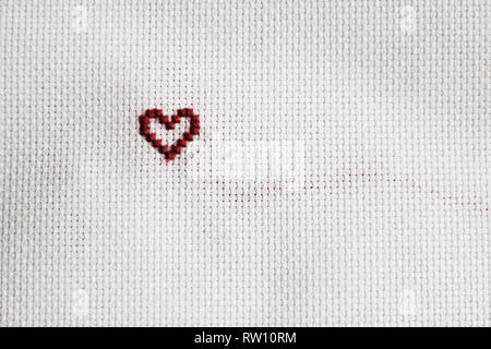 Heart shape, hand-embroidered, white canvas Stock Photo