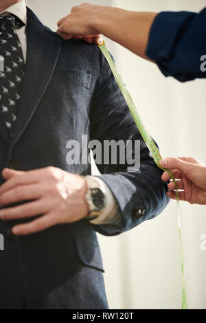 Taking measures of sleeve Stock Photo