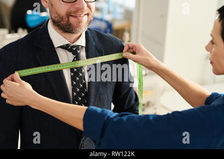 Tailor working with client Stock Photo