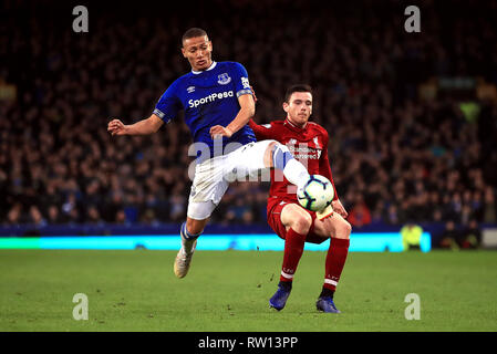 Everton's Richarlison (left) and Liverpool's Andrew Robertson battle for the ball during the Premier League match at Goodison Park, Liverpool. Stock Photo