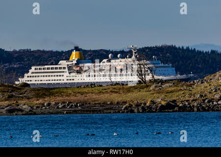 Cruise ship Saga Sapphire passing through narrow fjords on way to port of Bergen, Norway Stock Photo