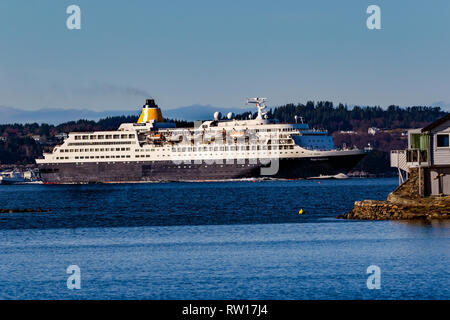 Cruise ship Saga Sapphire passing through narrow fjords on way to port of Bergen, Norway Stock Photo