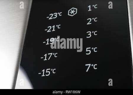Closeup of modern steel colored fridge and freezer control panel. Internet of things abstract concept. Stock Photo