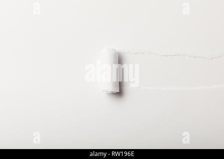 torn paper with rolled edge on white background Stock Photo
