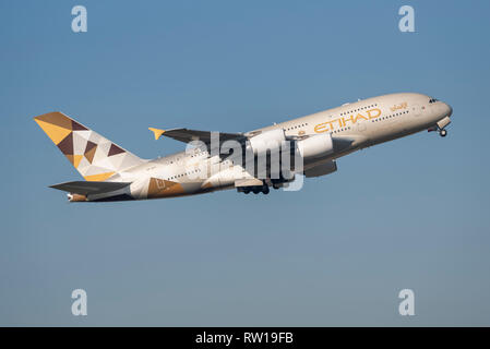 Etihad Airways Airbus A380 superjumbo jet airliner plane A6-APC taking off from London Heathrow Airport, UK, in blue sky Stock Photo