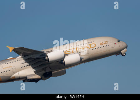 Etihad Airways Airbus A380 superjumbo jet airliner plane A6-APC taking off from London Heathrow Airport, UK, in blue sky Stock Photo