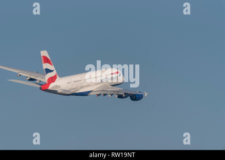 British Airways Airbus A380 superjumbo jet airliner plane G-XLEG taking off from London Heathrow Airport, UK, in blue sky Stock Photo