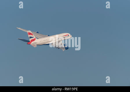 British Airways Airbus A380 superjumbo jet airliner plane G-XLEG taking off from London Heathrow Airport, UK, in blue sky Stock Photo