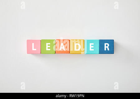 top view of leader lettering made of multicolored blocks on grey background Stock Photo