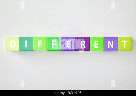 top view of different lettering made of multicolored cubes on grey background Stock Photo
