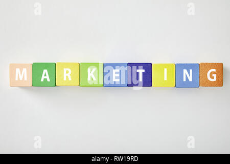 top view of marketing lettering made of multicolored cubes on grey background Stock Photo