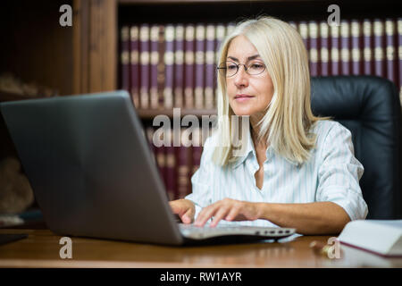 Woman using her laptop computer Stock Photo