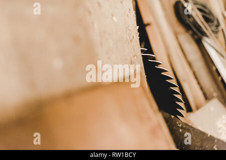 selective focus of round metal saw disc cutting wooden plank Stock Photo