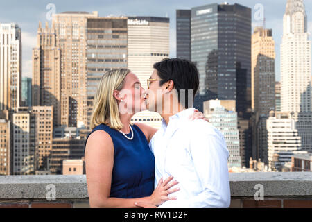 Attractive Mixed Race Couple Pose on Rooftop, NYC, USA Stock Photo