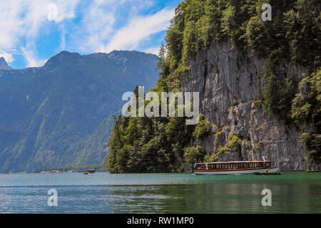 A boat in front of the Mountains of the Koenigssee Stock Photo