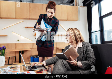 Secretary making notes while listening to instructions of boss Stock Photo