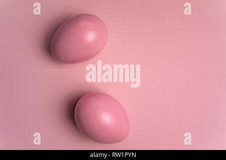 Pink easter eggs on pastel pink background with space for text - minimalist easter background Stock Photo