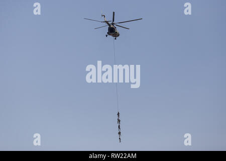 Kathmandu, Nepal. 4th Mar, 2019. Nepalese Army soldiers demonstrate rescue skills aboard of an helicopter during the Nepal Army Day celebration. Nepal Army Day is celebrated annually during Hindu festival Shivaratri. Credit: Sunil Pradhan/SOPA Images/ZUMA Wire/Alamy Live News Stock Photo