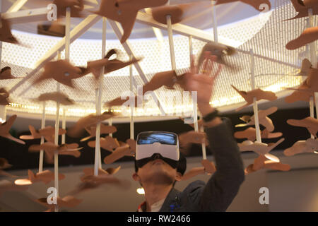 Singapore. 4th Mar, 2019. A visitor views the exhibits with Virtual Reality (VR) headset during the opening ceremony of the Singapore Design Week held at Singapore's National Design Centre in Singapore, March 4, 2019. Credit: Then Chih Wey/Xinhua/Alamy Live News Stock Photo