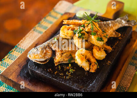 Trout on the stone; whole trout, served on hot stone with shrimp Stock Photo