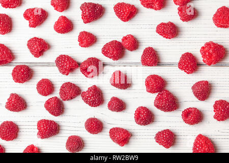 Tabletop view - raspberries scattered on white boards. Stock Photo