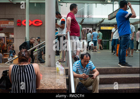 24.02.2019, Singapore, Republic of Singapore, Asia - People are bustling in front of an entrance to the Chinatown MRT station. Stock Photo