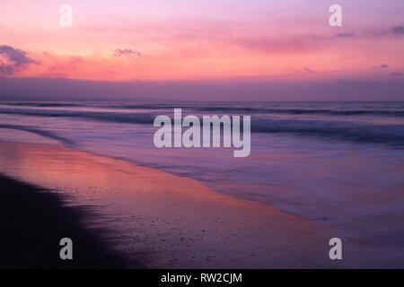 Dramatic sunset on the beach, with pink and blue tones Stock Photo