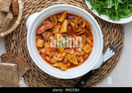 Tripes in clay pot. Top view. Rustic appearance. (Callos a la Madrileña). Stock Photo